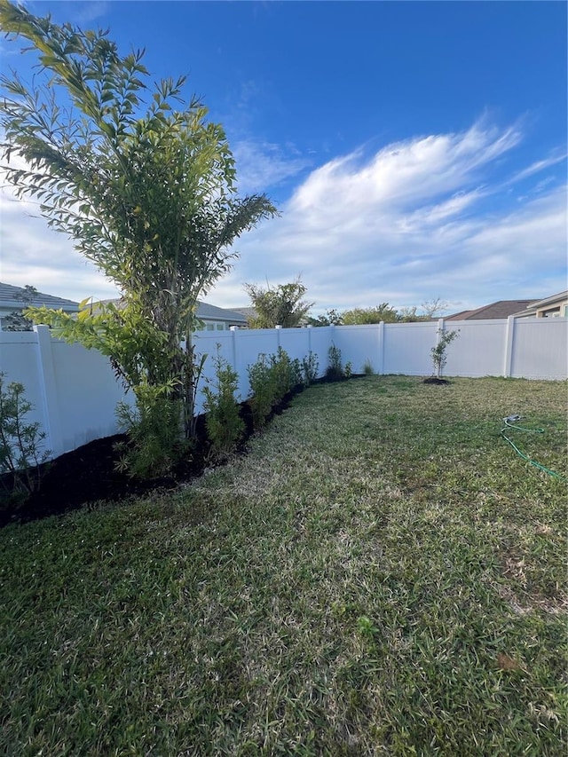 view of yard with a fenced backyard