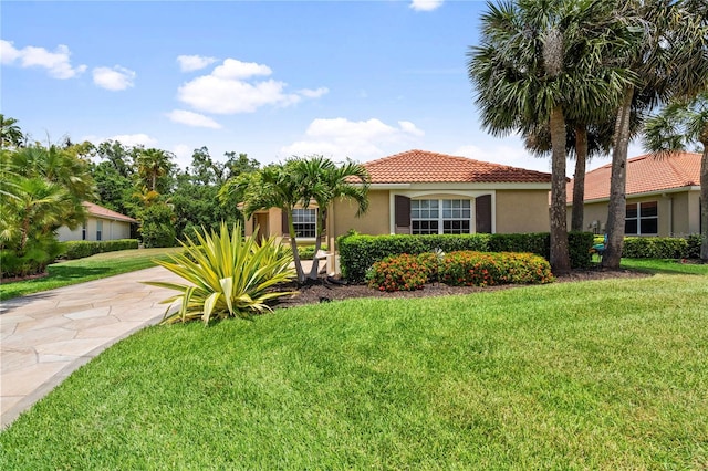 mediterranean / spanish house with a front yard