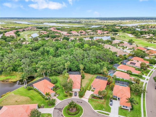 drone / aerial view with a water view, a residential view, and golf course view