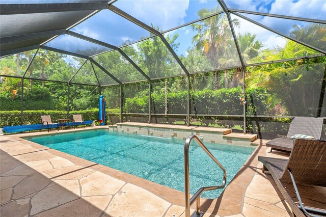 view of swimming pool with a patio and glass enclosure