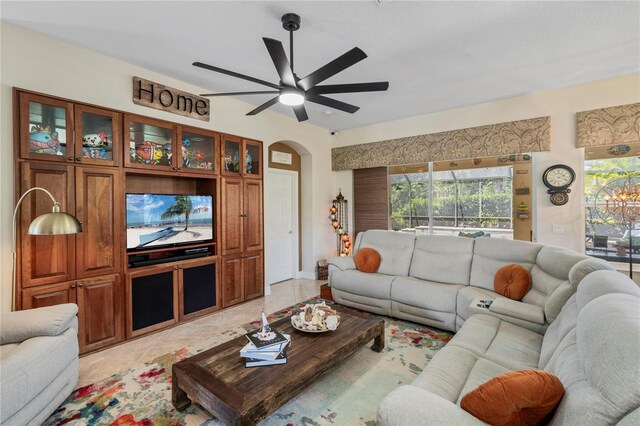 tiled living room with ceiling fan