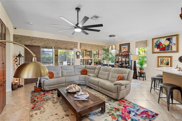 tiled living room featuring a healthy amount of sunlight and ceiling fan