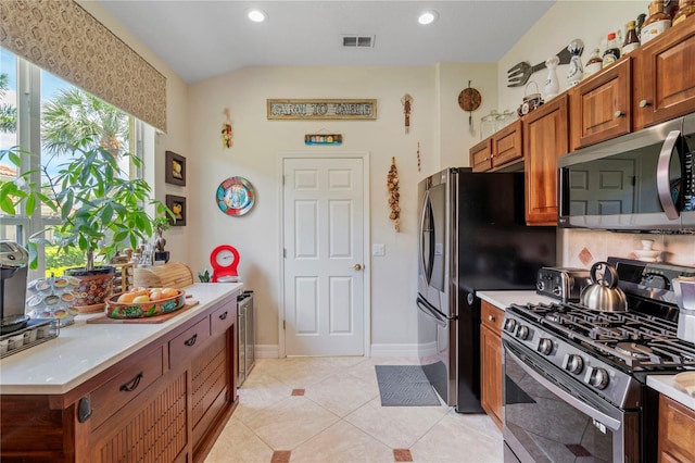 kitchen featuring light tile patterned flooring and appliances with stainless steel finishes