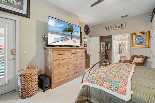 carpeted bedroom featuring ensuite bathroom and ceiling fan