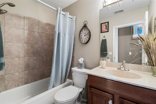 full bathroom with vanity, a textured ceiling, shower / bath combo, and toilet