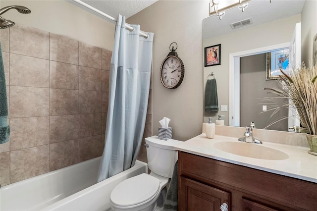 full bathroom with shower / bath combination with curtain, vanity, toilet, and a textured ceiling