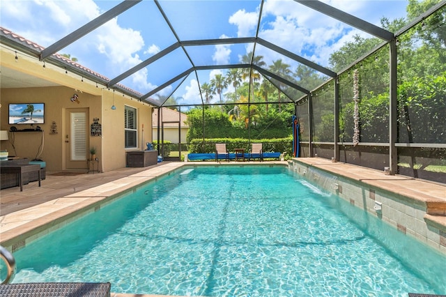 view of pool featuring pool water feature, a lanai, and a patio