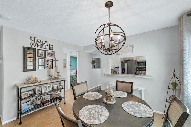 dining room with light tile flooring and an inviting chandelier