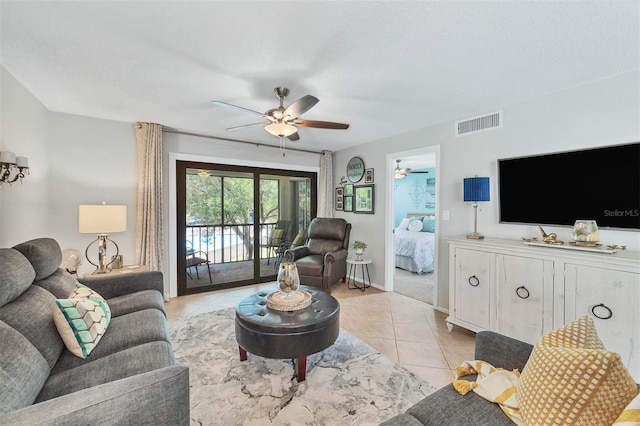 living room with ceiling fan and light tile floors