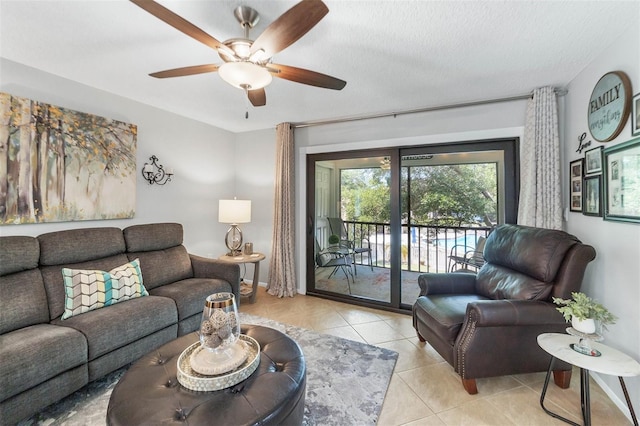 tiled living room with ceiling fan and a textured ceiling