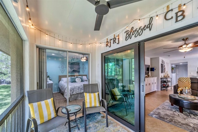 sunroom / solarium featuring ceiling fan