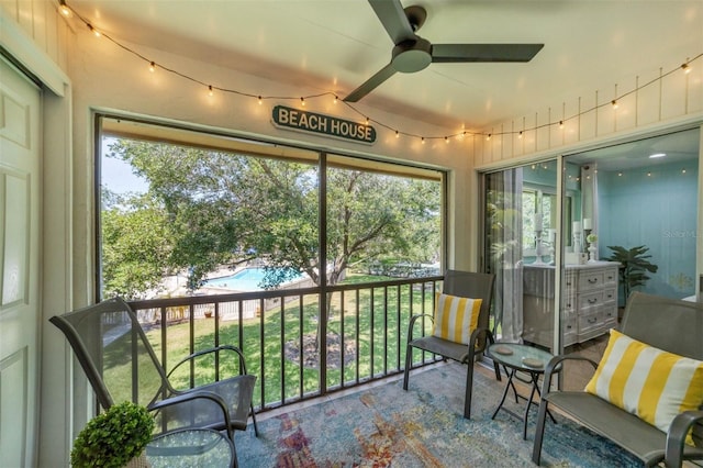 sunroom featuring ceiling fan