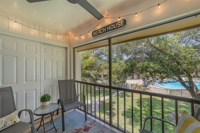 sunroom / solarium featuring ceiling fan