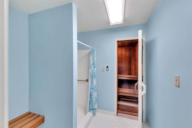 bathroom featuring a shower with shower curtain and tile floors