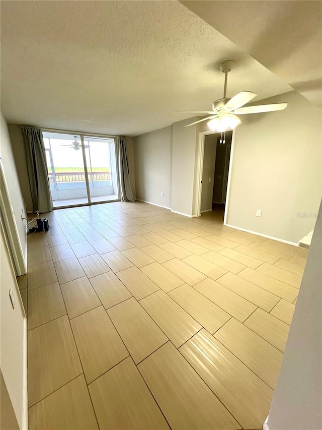 spare room featuring ceiling fan and a textured ceiling