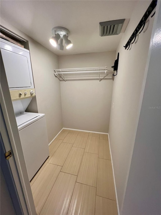 laundry room with stacked washer and clothes dryer