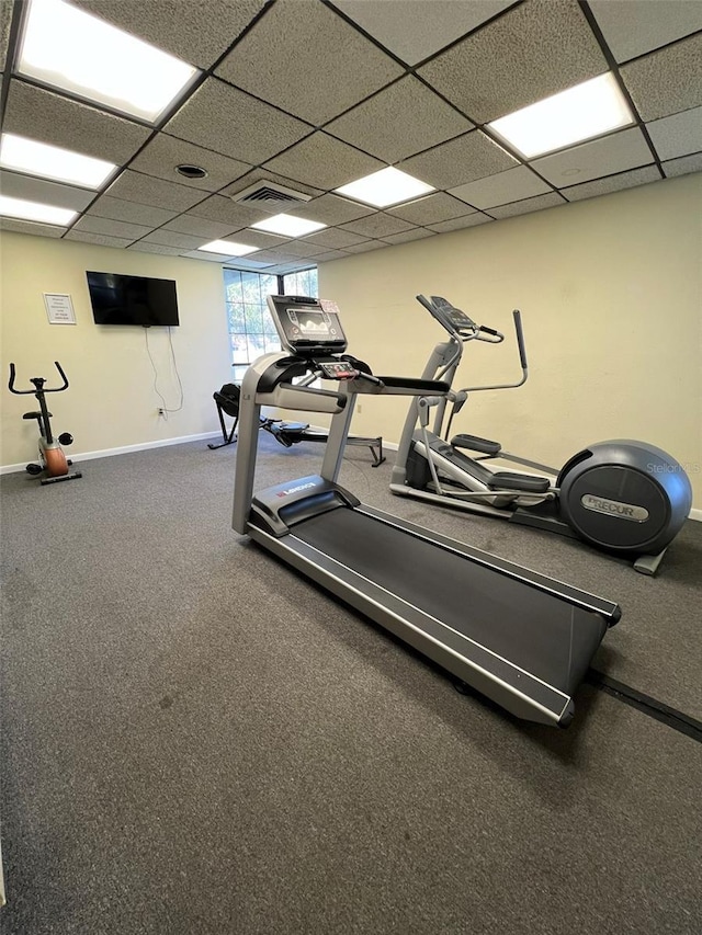 gym with a paneled ceiling