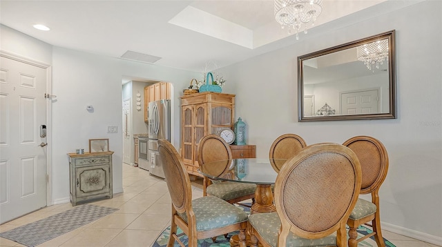 tiled dining space with an inviting chandelier