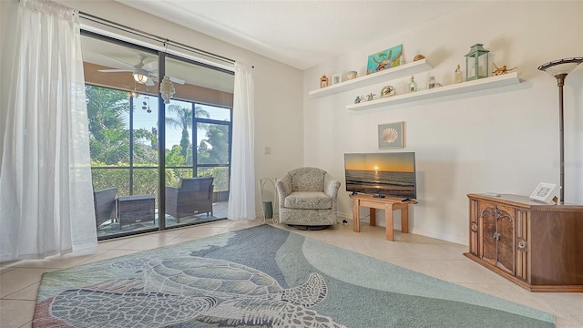 sitting room featuring ceiling fan and light tile floors