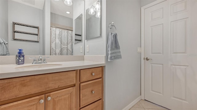 bathroom featuring tile flooring and vanity