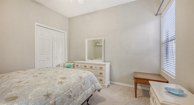 carpeted bedroom featuring a closet and ceiling fan