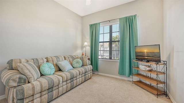 living room featuring carpet floors and vaulted ceiling