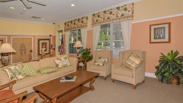 carpeted living room featuring crown molding and ceiling fan