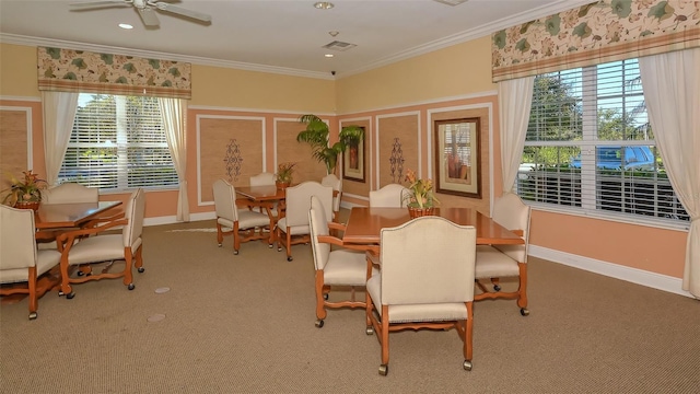 carpeted dining space with ornamental molding and ceiling fan