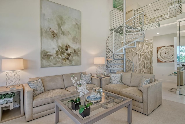 living room with a high ceiling and carpet