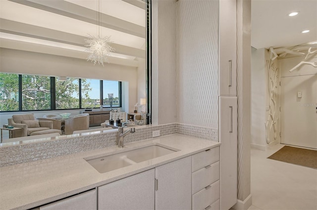 bathroom featuring tile floors, vanity, and a notable chandelier