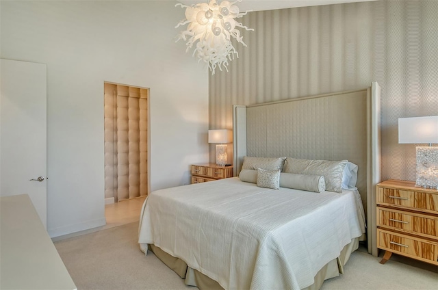 bedroom with a chandelier and light carpet