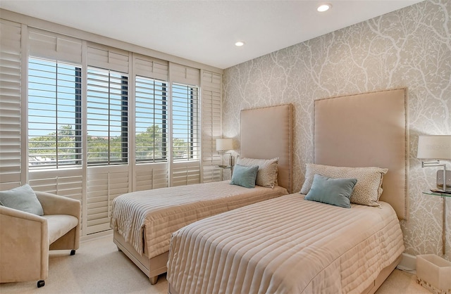 carpeted bedroom featuring multiple windows