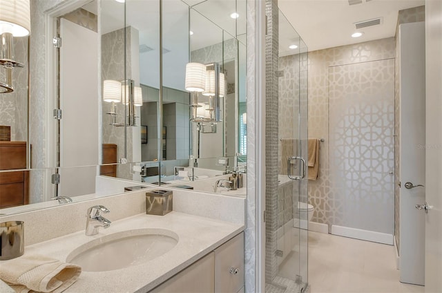 bathroom featuring oversized vanity, tile floors, and a shower with shower door