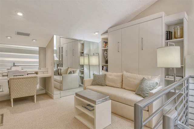 living room with light colored carpet and vaulted ceiling