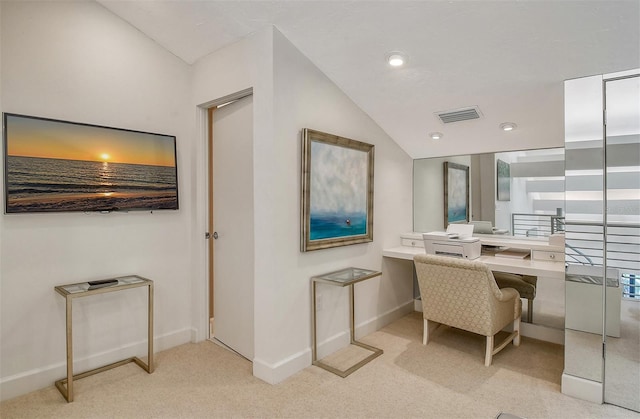 carpeted office with vaulted ceiling