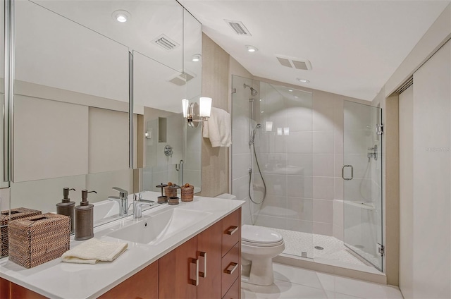 bathroom featuring tile floors, vanity with extensive cabinet space, toilet, and walk in shower