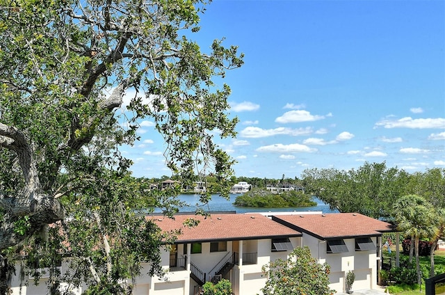 exterior space with a water view and a balcony