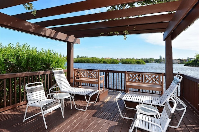 wooden terrace featuring a water view and a pergola