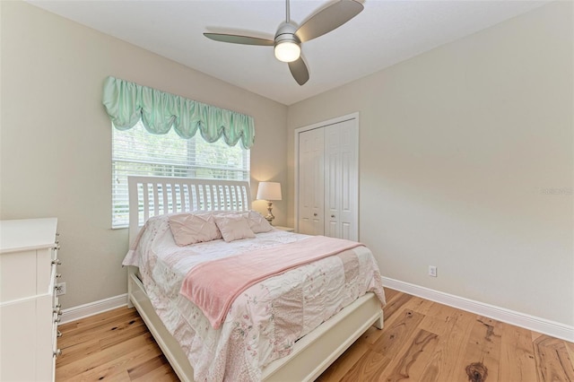 bedroom featuring ceiling fan, light hardwood / wood-style floors, and a closet