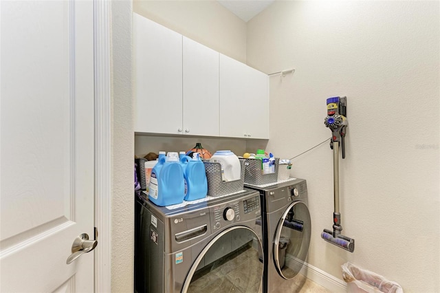 washroom featuring tile patterned flooring, separate washer and dryer, and cabinets