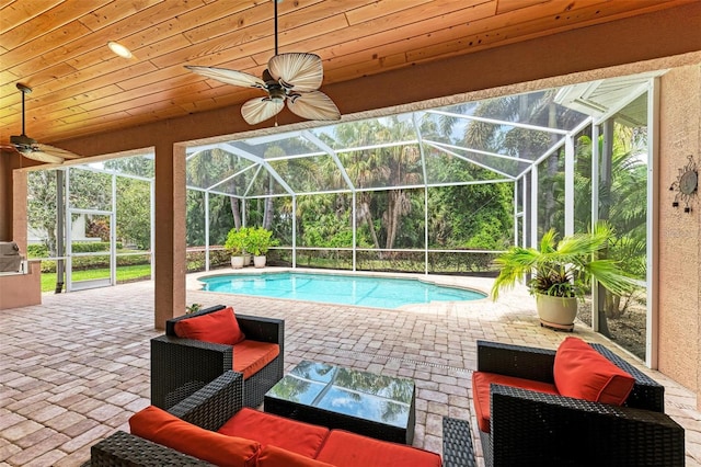 view of pool featuring a lanai, ceiling fan, and a patio