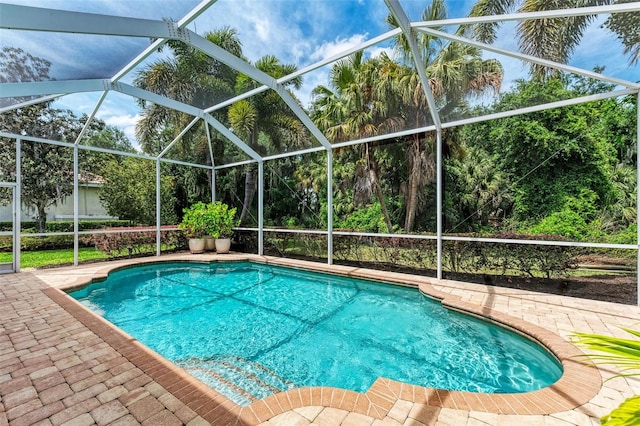 view of pool featuring a lanai and a patio