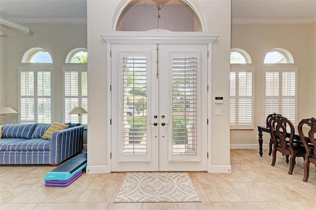 doorway with light tile patterned floors, crown molding, and french doors