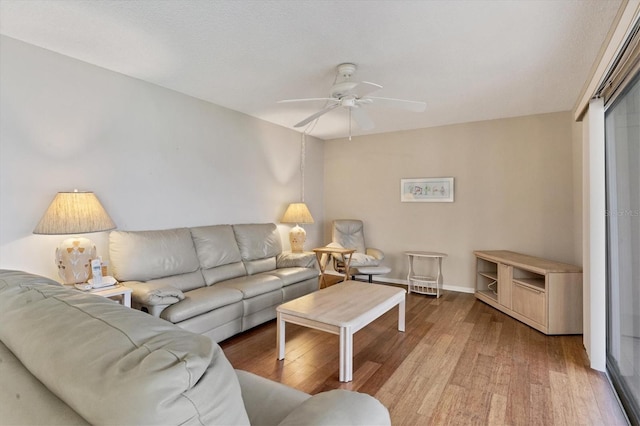 living room with ceiling fan and light hardwood / wood-style floors