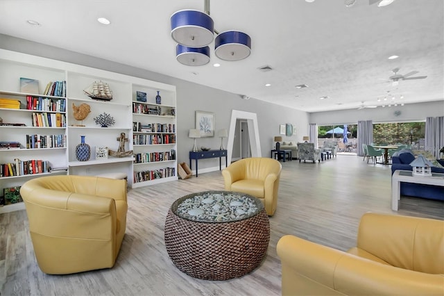 sitting room featuring ceiling fan and light hardwood / wood-style flooring