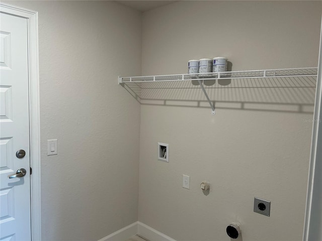 clothes washing area with washer hookup, gas dryer hookup, electric dryer hookup, laundry area, and baseboards