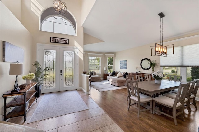 tiled foyer with a notable chandelier and french doors