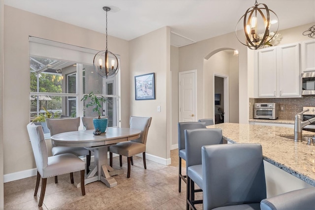 dining space with light tile patterned flooring and sink