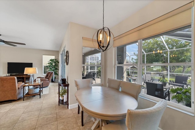 dining room with light tile patterned flooring and ceiling fan with notable chandelier