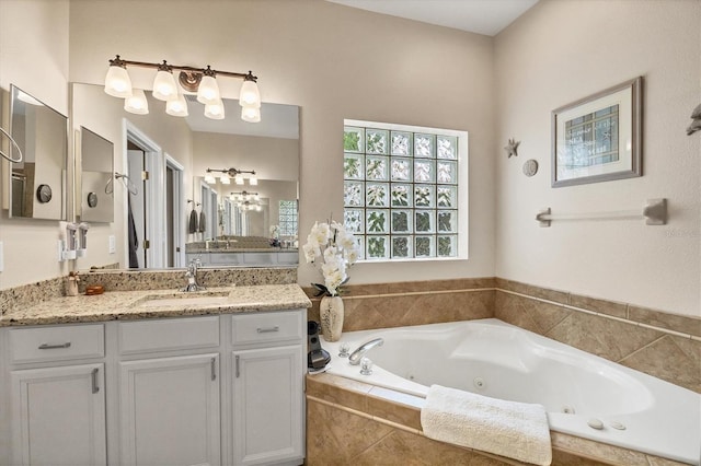 bathroom featuring vanity and tiled tub